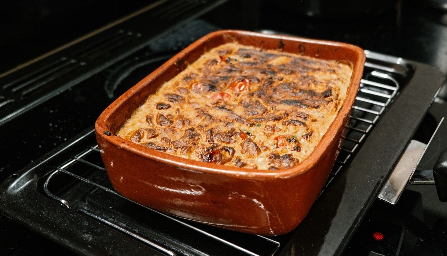 Freshly baked vegetarian dish cooling in a terracotta dish during a hands-on cooking experience at Figs on the Funcho in the Algarve