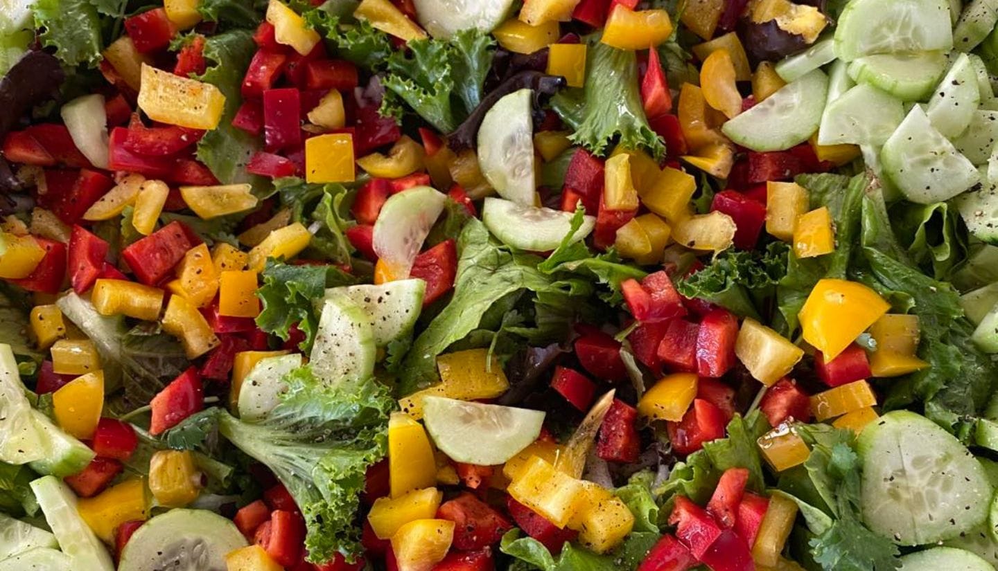 Fresh mixed salad with cucumber, peppers and leaves prepared during a cooking experience at Figs on the Funcho in the Algarve.