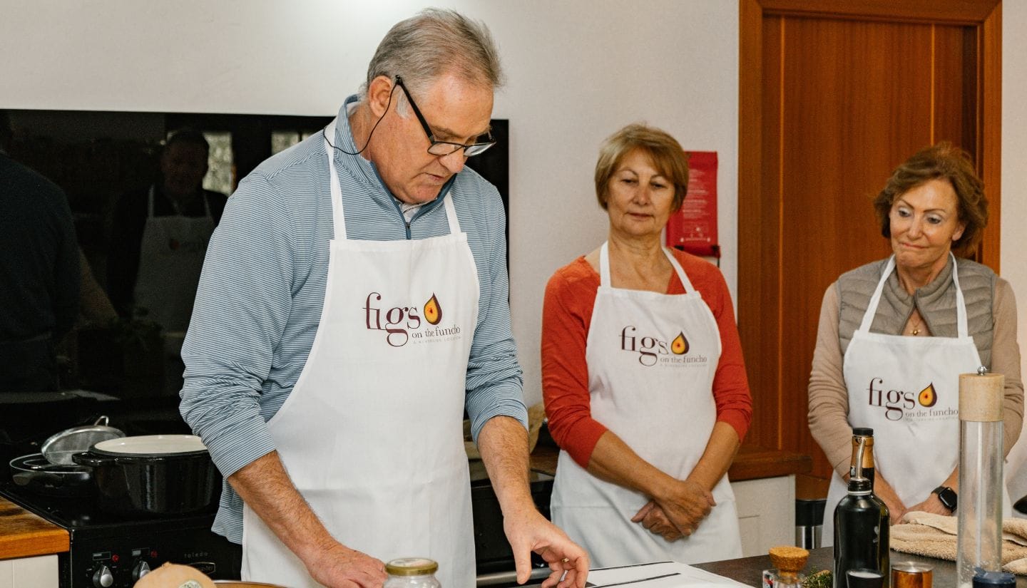 Guests receiving guidance during a hands-on cooking experience at Figs on the Funcho in the Algarve.